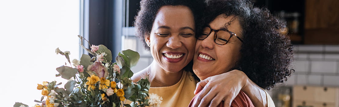 Mature woman giving flowers to her wife